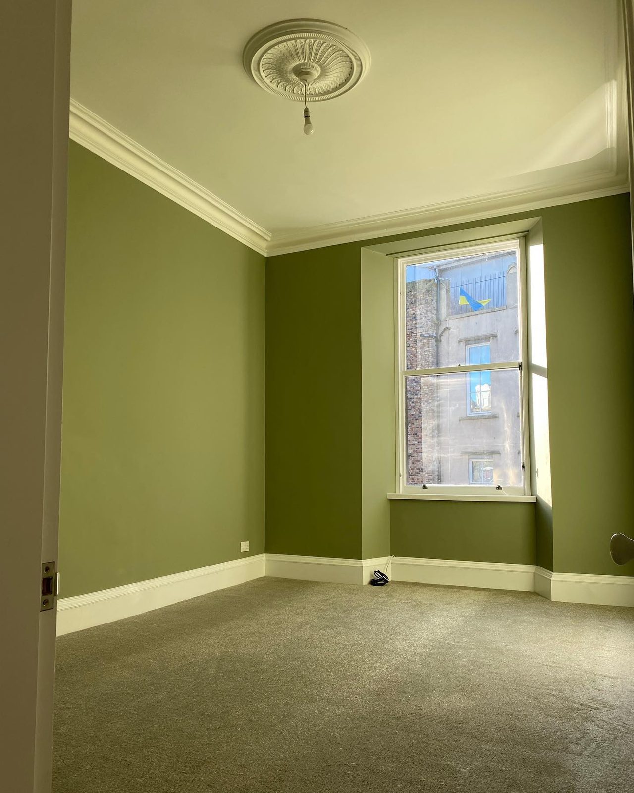 Room renovation with green wall panelling